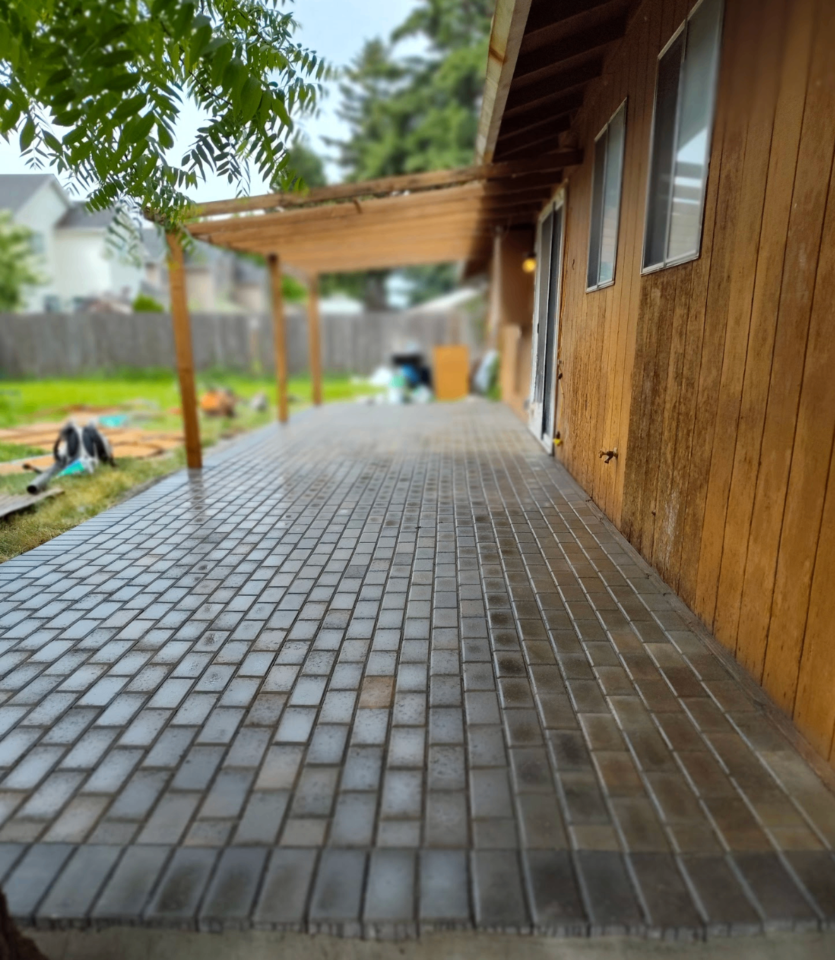 Long covered patio with brick-style pavers