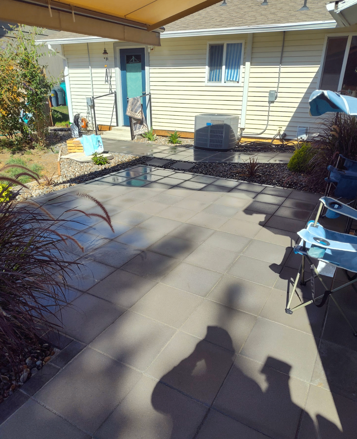 Large modern paver patio at the back of a home